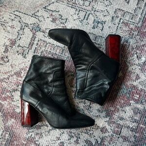 Elegant Black Leather Heeled Boots with Red Accents